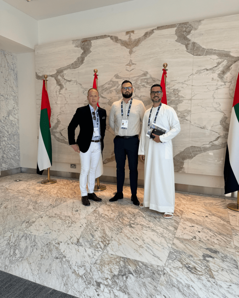 Delegates received at a government building beside the UAE flags